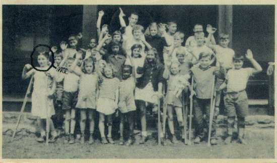 Group photograph of campers waving.  One girl is circled in pen and labelled "Me."