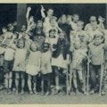 Group photograph of campers waving.  One girl is circled in pen and labelled Me.
