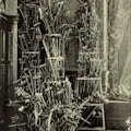 Photograph of a large pyramid of Crutches in the corner of a church.