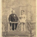 Full frontal view of Mr. and Mrs. Thumb standing on a balcony.