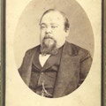 Bust view, oval format, of Tom Thumb in his later years, with beard and wearing coat and vest.
