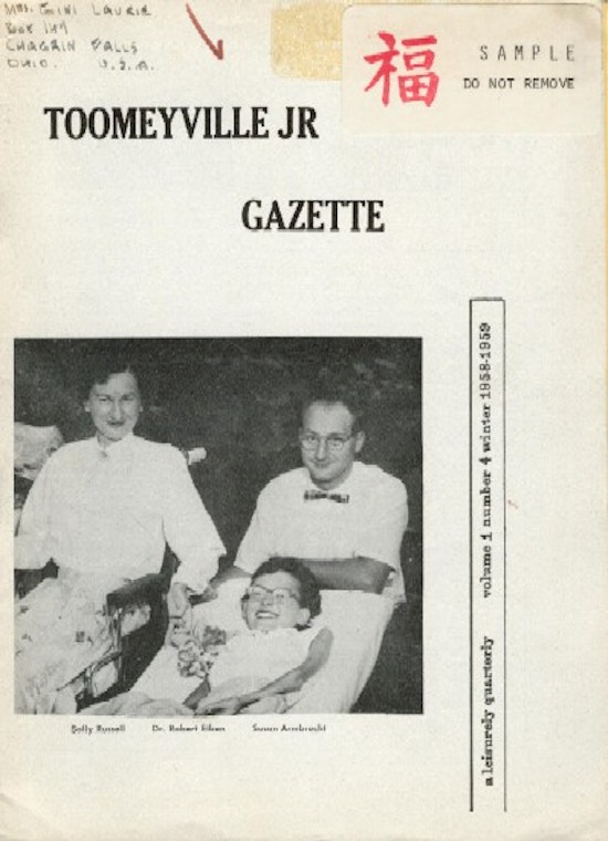 Magazine cover, with smiling man, woman, and girl.