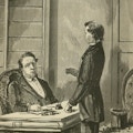 A man speaks with another sitting at a desk.
