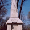 A very monument with a life-size statute of Tom Thumb on top.