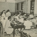 Children crowded around dining tables.