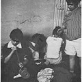 Four children in a dilapidated room.