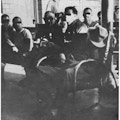 Men in chairs on a ward.