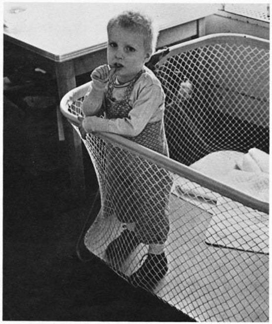 A boy in a playpen.