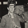 A man wearing a welding shield.