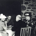 King George sits at a table with two women and a man outside Top Cottage.