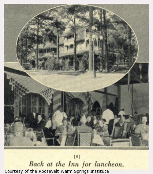 A large wooden building among trees and people sitting down for lunch.