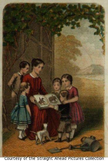 A color picture of a woman under a tree showing a book of animal pictures to a group of children