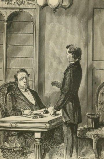 A man speaks with another sitting at a desk.