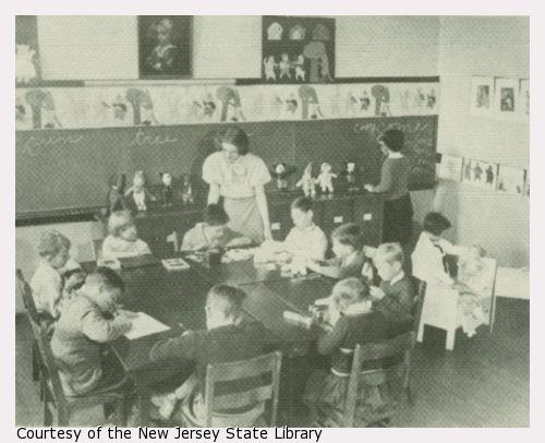 A teacher supervises a classroom with eleven children.