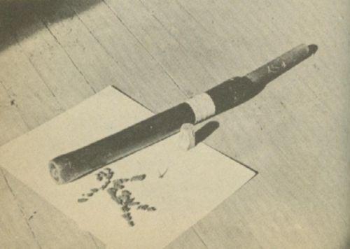 A weapon made of rubber hose laying on a table.