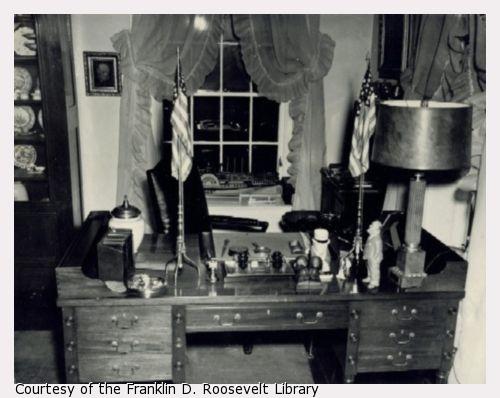 A desk with FDR momentos, including a photograph of Winston Churchill.