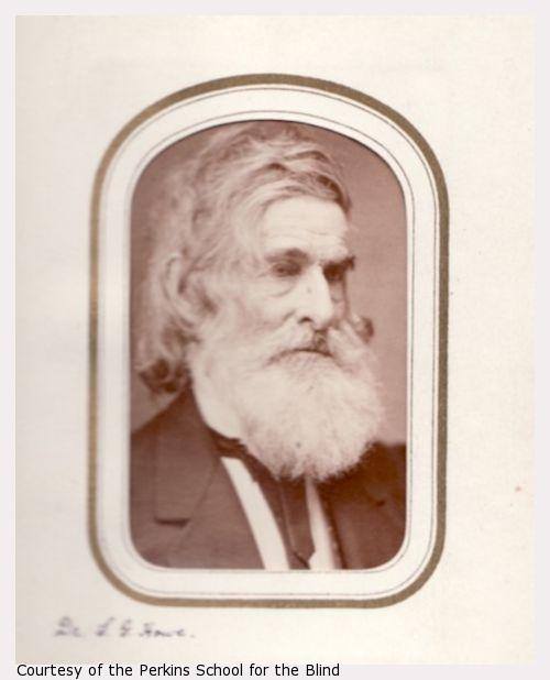 Samuel Gridley Howe, waist-up portrait, dark suit, gray hair and beard.