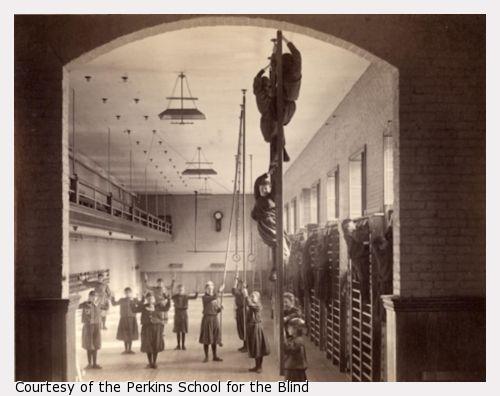 Photo of female students wearing bloomers, climbing and performing calisthenics.