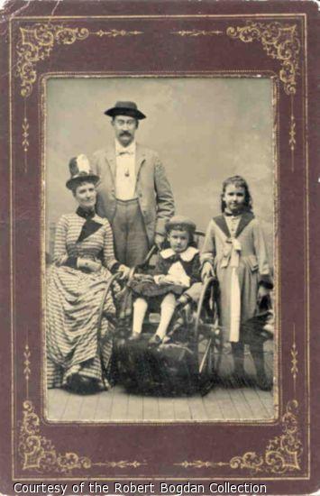 Portrait of mother, father, and two children, one in a wheelchair.