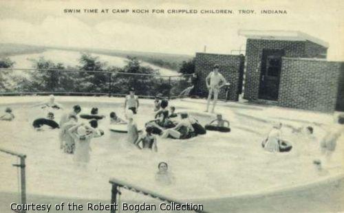 Postcard photograph of children playing in a pool.
