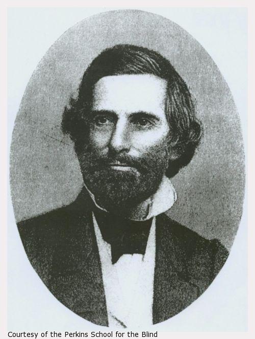 Howe with dark suit, white shirt with high collar, beard and mustache