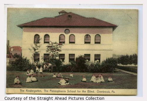 The Kindergarten, The Pennsylvania School for the Blind, Overbrook, Pennsylvania. A two-story building with tile roof, children in front.