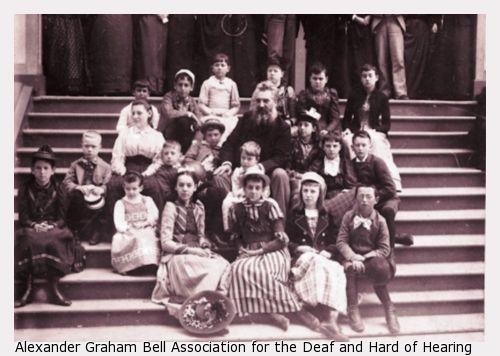 Bell with a group of children sitting on steps.