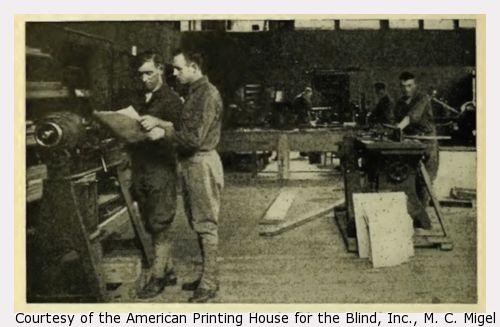 Men working at carpentry machinery.