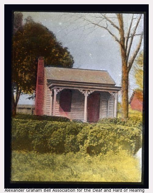 A small cottage with shrubs in foreground near Helen Keller's childhood home in Tuscumbia, Alabama.