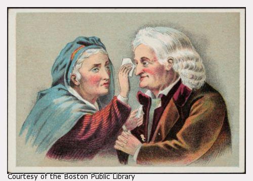 Elderly woman applying liquid to elderly man's eye.