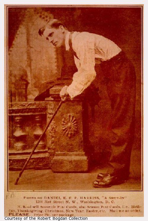 Sepia toned photo of man hunched over holding a cane.