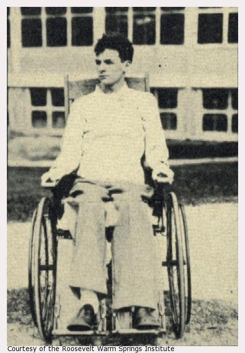A young man sits in a wheelchair.